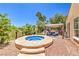 Backyard oasis featuring a spa, pergola, and outdoor seating at 27 Via Paradiso St, Henderson, NV 89011