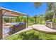 Backyard featuring a grill, spa, and covered lounge area at 27 Via Paradiso St, Henderson, NV 89011