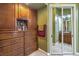 Bathroom including wood cabinets, a mirrored closet, and view into a neighboring washroom at 27 Via Paradiso St, Henderson, NV 89011