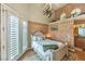 Comfortable bedroom with decorative accents, high ceilings, and access to a bathroom at 27 Via Paradiso St, Henderson, NV 89011
