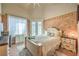 Cozy bedroom featuring a comfortable bed, decorative wall details, and French doors to the outside at 27 Via Paradiso St, Henderson, NV 89011