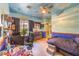 Cozy bedroom featuring painted mural on walls and ceiling, ceiling fan, and desk at 27 Via Paradiso St, Henderson, NV 89011