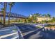 Welcoming entrance to Lake Las Vegas with lush landscaping, palm trees, and convenient access to shopping and dining at 27 Via Paradiso St, Henderson, NV 89011