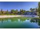 Serene community pool featuring a waterfall and sandy beach, perfect for relaxation and recreation at 27 Via Paradiso St, Henderson, NV 89011