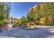 Charming courtyard with a decorative fountain, manicured plants, and wrought iron railings at 27 Via Paradiso St, Henderson, NV 89011