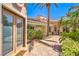 Beautiful entryway with pavers, desert landscaping, and a large palm tree at 27 Via Paradiso St, Henderson, NV 89011
