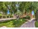 Landscaped front yard with mature trees and brick walkway leading to the home's entrance at 27 Via Paradiso St, Henderson, NV 89011