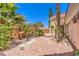 Charming courtyard with a fountain and lush landscaping, creating a private oasis at 27 Via Paradiso St, Henderson, NV 89011