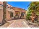 Inviting front exterior featuring a decorative fountain, lush plants, and a welcoming entryway at 27 Via Paradiso St, Henderson, NV 89011