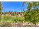 Scenic view of a lush green golf course and homes on the hill, with trees and blue skies at 27 Via Paradiso St, Henderson, NV 89011