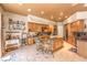 Gourmet kitchen featuring custom cabinetry, granite countertops, a central island, and travertine tile flooring at 27 Via Paradiso St, Henderson, NV 89011