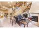 Elegant living room featuring a spiral staircase, fireplace, and comfortable seating at 27 Via Paradiso St, Henderson, NV 89011