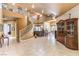 Grand living room featuring a spiral staircase, high ceilings, and tile flooring at 27 Via Paradiso St, Henderson, NV 89011