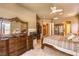 Well-lit main bedroom with a four-poster bed, private ensuite, fireplace, and ample closet space at 27 Via Paradiso St, Henderson, NV 89011