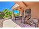 Covered patio featuring a pool table, chairs, and lush landscaping at 27 Via Paradiso St, Henderson, NV 89011