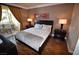 A cozy bedroom with a comfortable bed, sleek nightstands, and a private balcony at 270 E Flamingo Rd # 319, Las Vegas, NV 89169