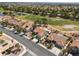 Aerial view of a neighborhood near a lush golf course with ponds, mature trees and well-maintained homes at 2816 Golfside Dr, Las Vegas, NV 89134