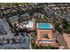 Aerial view of community amenities with tennis courts, swimming pool, covered seating and lush, mature landscaping at 2816 Golfside Dr, Las Vegas, NV 89134