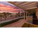 Inviting covered back patio overlooking the lush golf course with stunning sunset views at 2816 Golfside Dr, Las Vegas, NV 89134