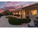 Exterior dusk view showcases a well-manicured lawn and neutral-toned backyard at 2816 Golfside Dr, Las Vegas, NV 89134