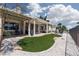 Well-manicured backyard with neutral stone, turf, and patio; overlooks golf course at 2816 Golfside Dr, Las Vegas, NV 89134