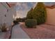 Charming backyard with walkway, mature trees, and decorative rock landscaping at 2816 Golfside Dr, Las Vegas, NV 89134