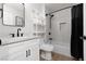 Modern bathroom featuring a white vanity, subway tile shower, and black hardware at 2816 Golfside Dr, Las Vegas, NV 89134