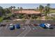 A clubhouse with a tile roof is landscaped with palm trees near a paved parking lot with handicap parking at 2816 Golfside Dr, Las Vegas, NV 89134
