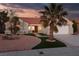 Inviting single-story home featuring lush landscape, desert rock and a two-car garage at 2816 Golfside Dr, Las Vegas, NV 89134
