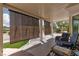 Covered patio boasts sunshades, neutral stone, and comfortable seating with outdoor views at 2816 Golfside Dr, Las Vegas, NV 89134