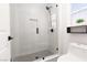 Modern bathroom with tiled shower and gray tile flooring at 2816 Golfside Dr, Las Vegas, NV 89134