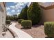 Charming side yard with desert landscape, leading to a tranquil and private outdoor area at 2816 Golfside Dr, Las Vegas, NV 89134