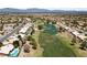 Scenic aerial shot of a well-maintained golf course community with lush greenery and a serene pond at 2816 High Range Dr, Las Vegas, NV 89134
