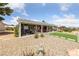 Backyard featuring a covered patio, artificial turf, desert landscaping, and relaxing lounge areas at 2816 High Range Dr, Las Vegas, NV 89134