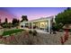 Backyard showing a covered patio with outdoor furniture, a well-kept lawn area, and mature desert landscaping at 2816 High Range Dr, Las Vegas, NV 89134