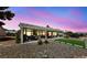 Inviting covered patio with stylish outdoor furniture and a manicured backyard perfect for entertaining at 2816 High Range Dr, Las Vegas, NV 89134