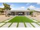 Outdoor living space with artificial turf, a covered patio, and desert landscaping at 2816 High Range Dr, Las Vegas, NV 89134
