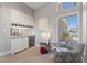 Home bar area with white cabinets, beverage fridge, and accent chair at 2816 High Range Dr, Las Vegas, NV 89134