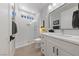 Bright bathroom featuring double sinks, a walk-in shower with glass door, and sleek fixtures at 2816 High Range Dr, Las Vegas, NV 89134