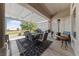 Relaxing covered patio offering a dining table, comfortable seating, a heater, and a serene backyard view at 2816 High Range Dr, Las Vegas, NV 89134