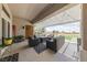 Inviting covered patio featuring comfortable seating, a stylish rug, and a view of a manicured lawn at 2816 High Range Dr, Las Vegas, NV 89134