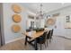 Dining room with views of the backyard, statement chandelier, and basket wall decor at 2816 High Range Dr, Las Vegas, NV 89134