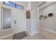Modern front door with sidelight, artwork, and woven basket wall decor at 2816 High Range Dr, Las Vegas, NV 89134