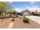 Single-story home showcasing desert landscaping, a two-car garage, and a welcoming entrance at 2816 High Range Dr, Las Vegas, NV 89134