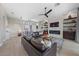 Bright living room boasts hardwood floors, a stone fireplace, a modern ceiling fan, and comfortable leather seating at 2816 High Range Dr, Las Vegas, NV 89134
