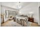 Bright bedroom boasts a bay window, chandelier, plantation shutters, and plush bedding at 3009 Anna Bay Dr, Las Vegas, NV 89134