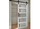 Modern closet featuring sliding door, ample shelving, and wood floors at 3009 Anna Bay Dr, Las Vegas, NV 89134