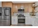 Kitchen features a stainless steel fridge, marble countertops, and open wood shelving at 3009 Anna Bay Dr, Las Vegas, NV 89134