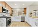 Updated kitchen with stainless steel appliances, white cabinets, and modern fixtures at 3009 Anna Bay Dr, Las Vegas, NV 89134