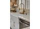 Close-up on updated kitchen with farmhouse sink, elegant faucet, and marble countertops at 3009 Anna Bay Dr, Las Vegas, NV 89134